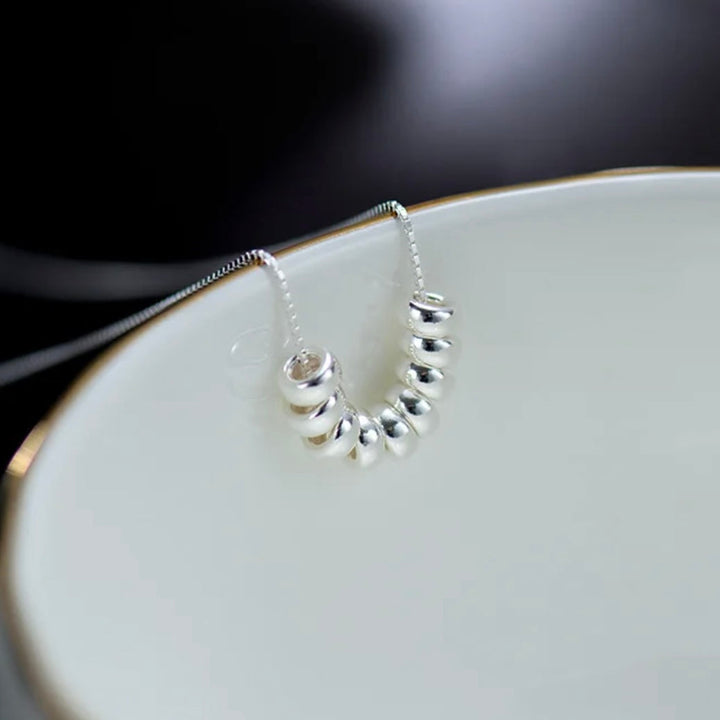 a close up of a plate with a necklace on it