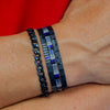 a man's arm with two bracelets on it
