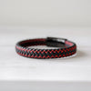 a red and black braided leather bracelet