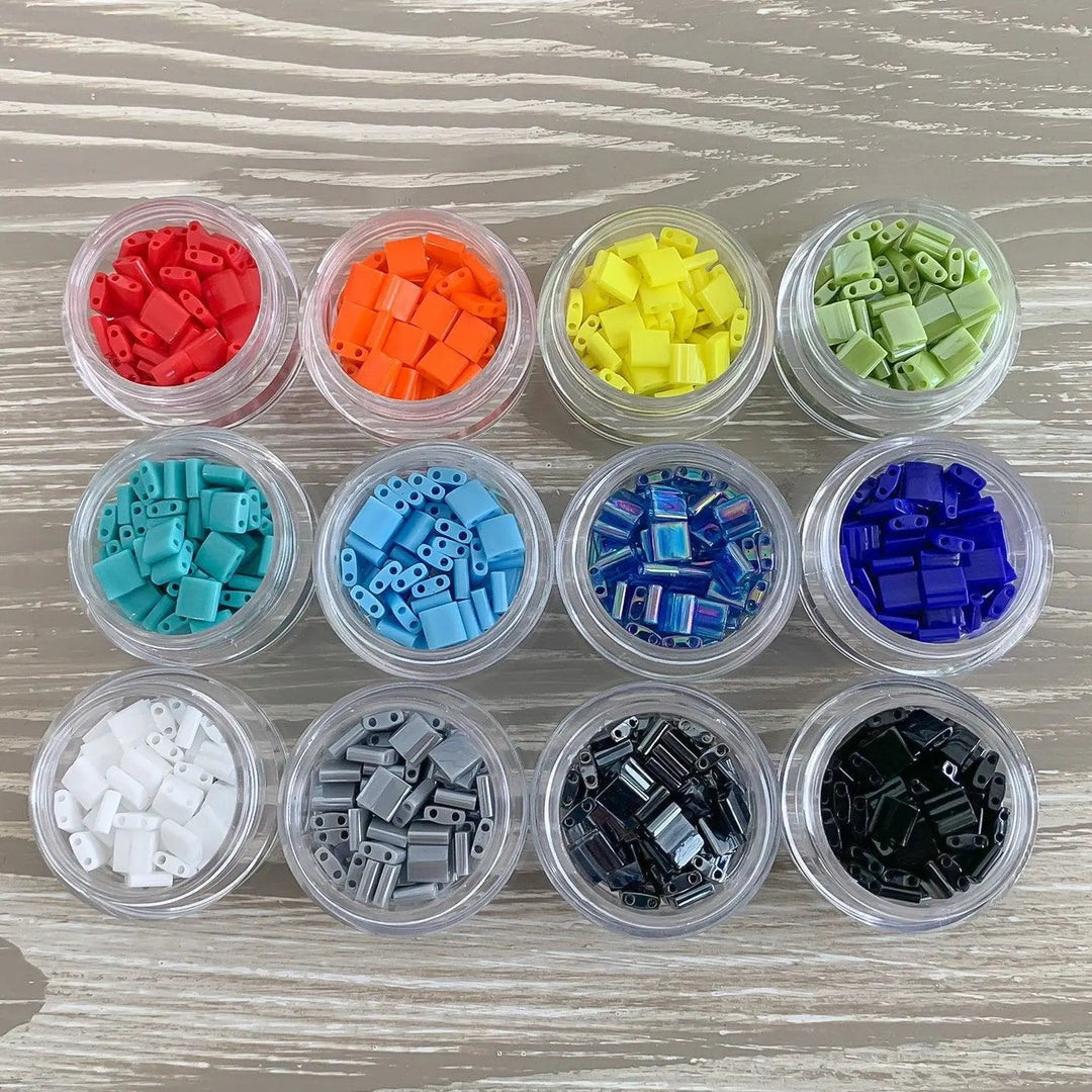 a group of small containers filled with different colored legos