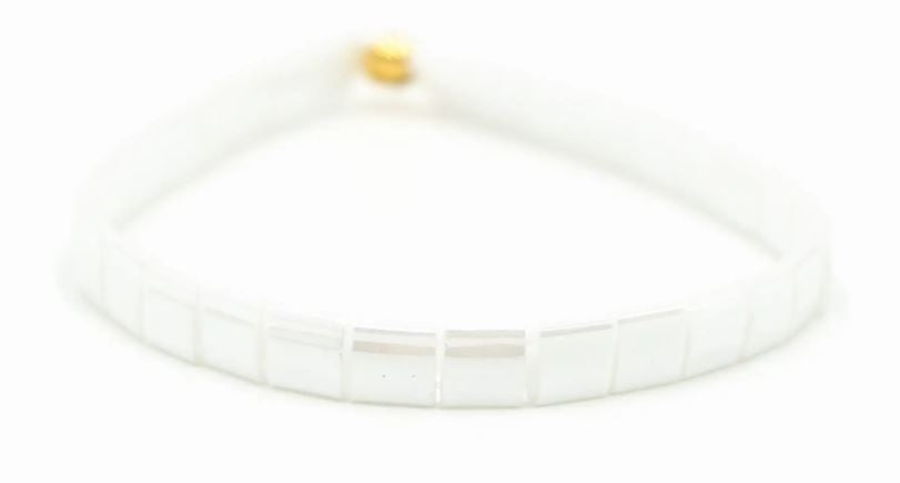 a close up of a white bracelet on a white background