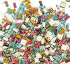 a pile of assorted colored beads on a white surface