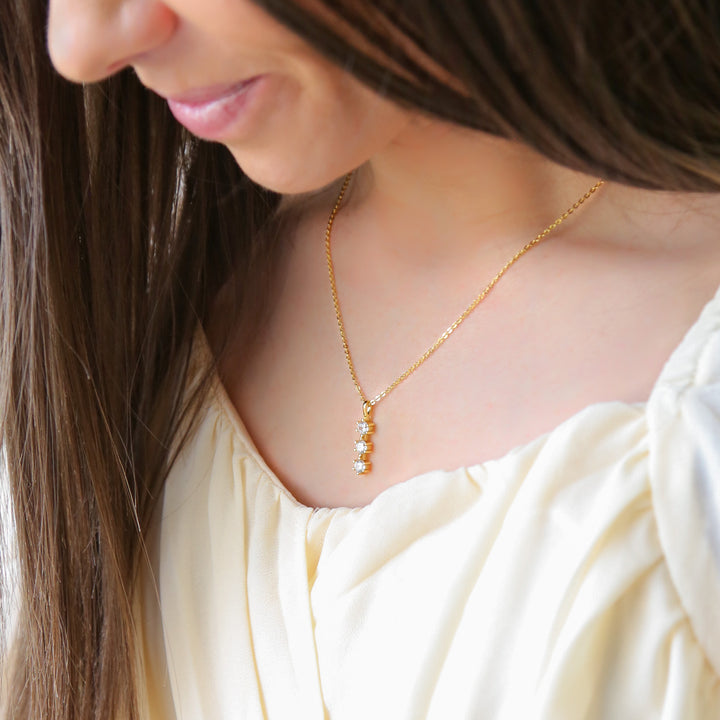 a close up of a woman wearing a necklace