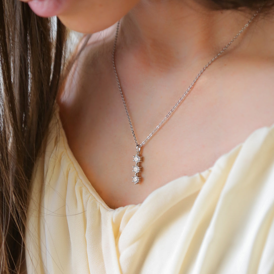 a close up of a woman wearing a necklace