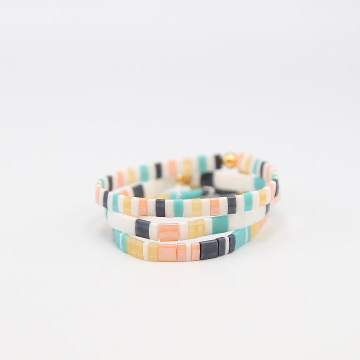 Set of 'Bikini Bottom' beaded bracelet stack on a white background