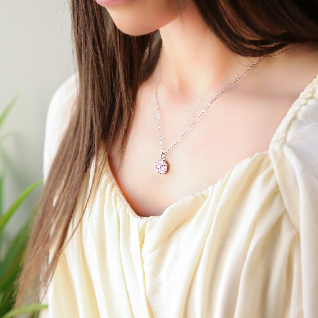 a woman wearing a white dress and a necklace