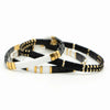 two black and white bracelets with gold accents