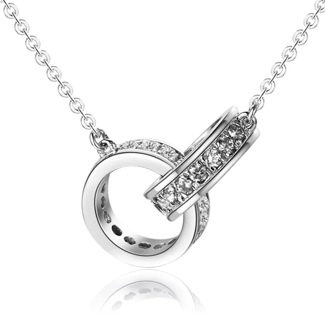 a white gold necklace with diamonds on a chain
