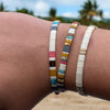 a close up of two bracelets on a person's arm