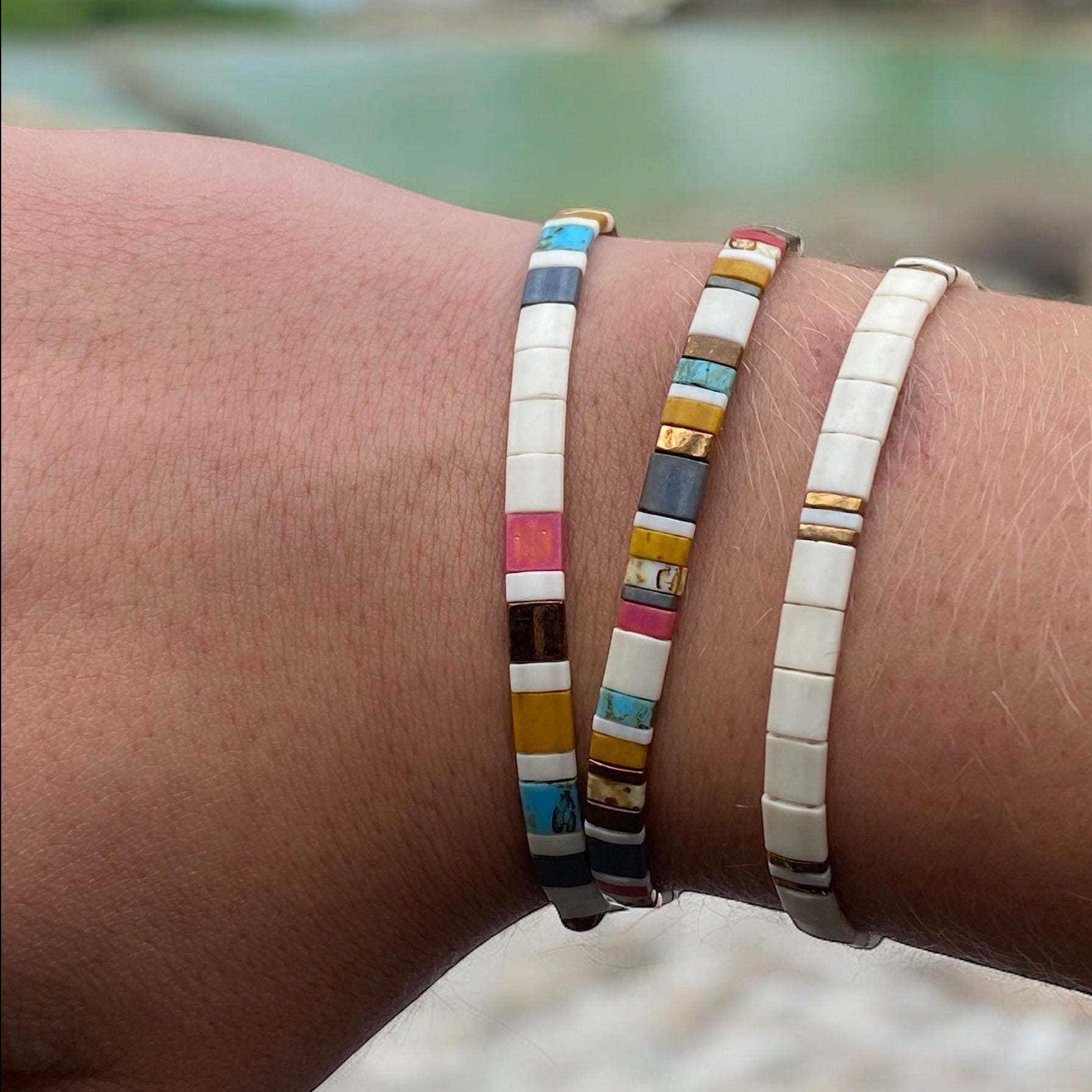a close up of two bracelets on a person's arm