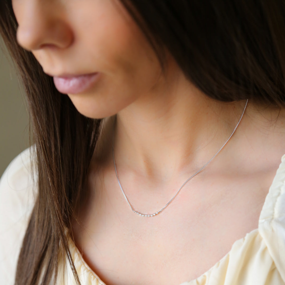 a close up of a woman wearing a necklace