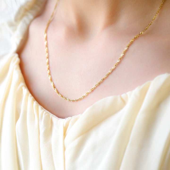 a close up of a woman wearing a necklace