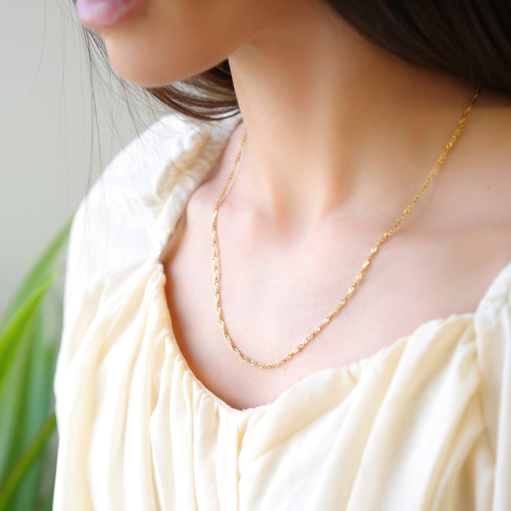 a close up of a woman wearing a necklace