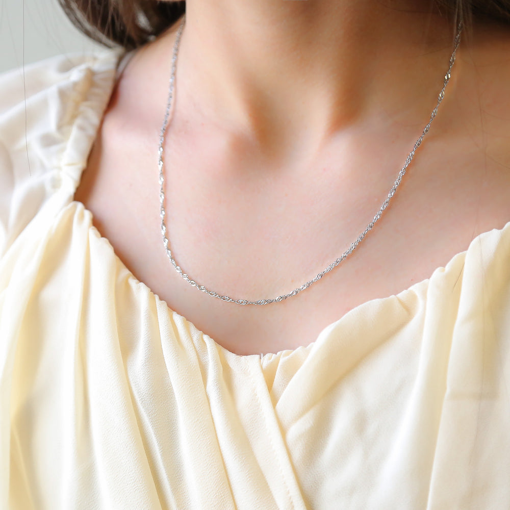 a close up of a woman wearing a necklace