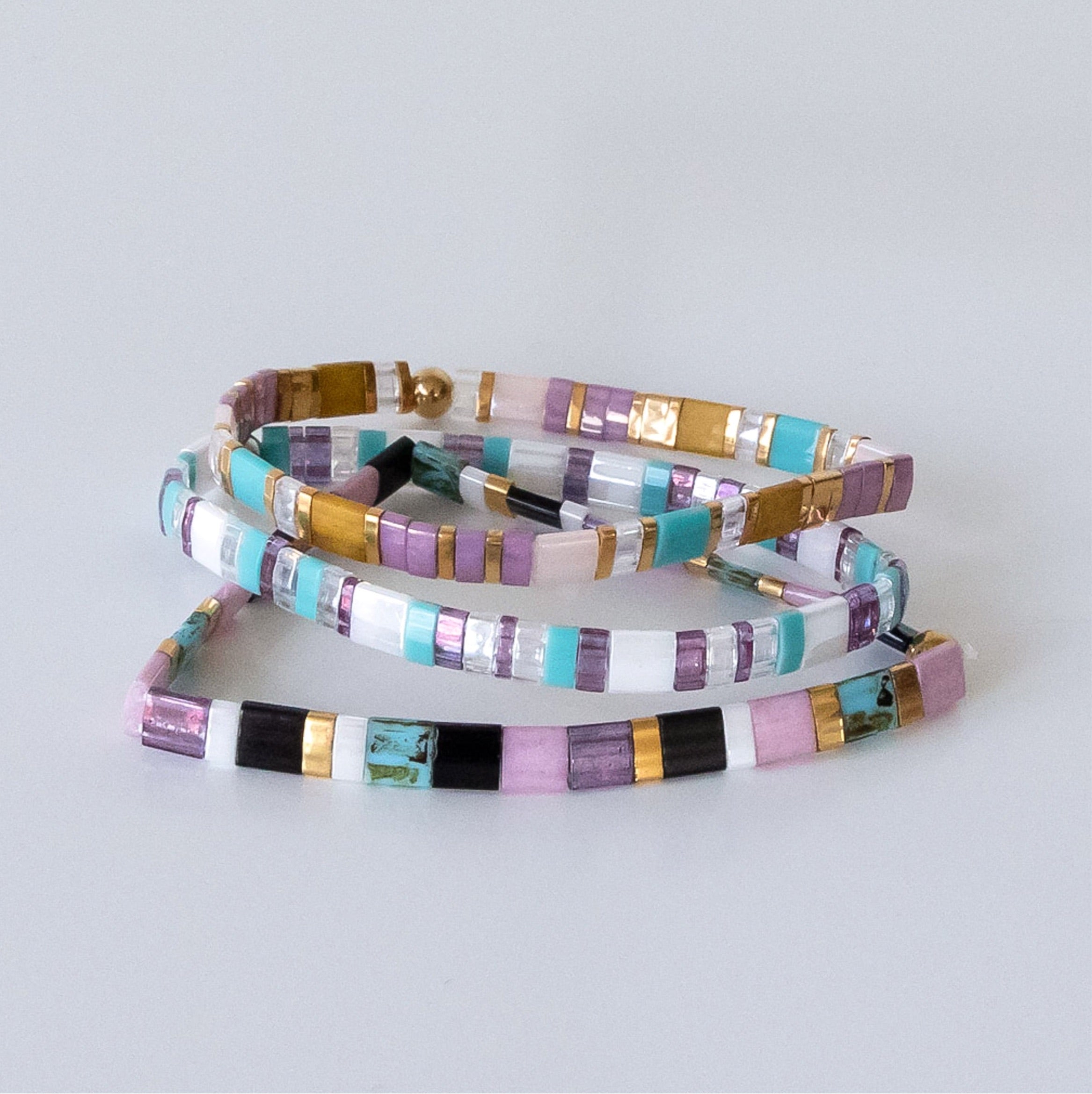 a set of three bracelets sitting on top of a table