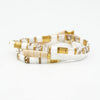 two white and gold bracelets on a white background
