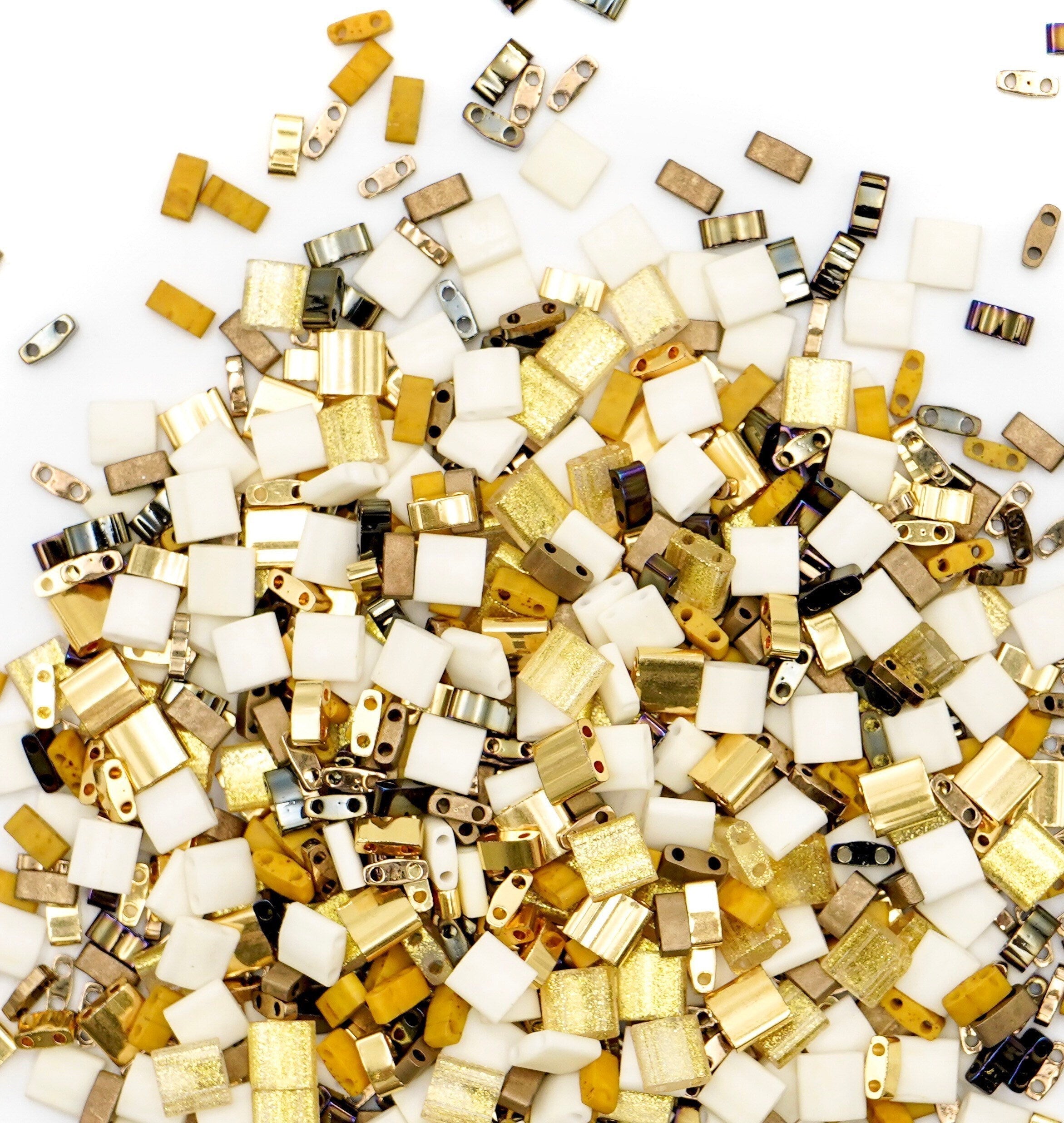 a pile of gold and white mosaic tiles