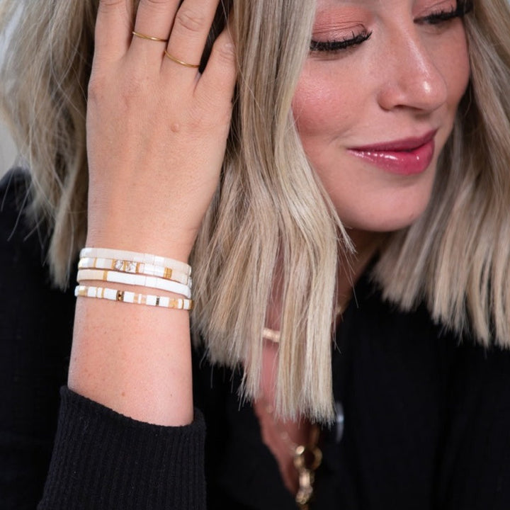 a woman with blonde hair wearing a bracelet