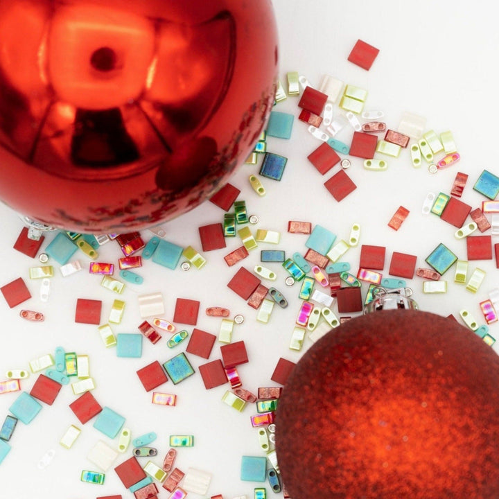 a pile of colorful glass beads on a white surface