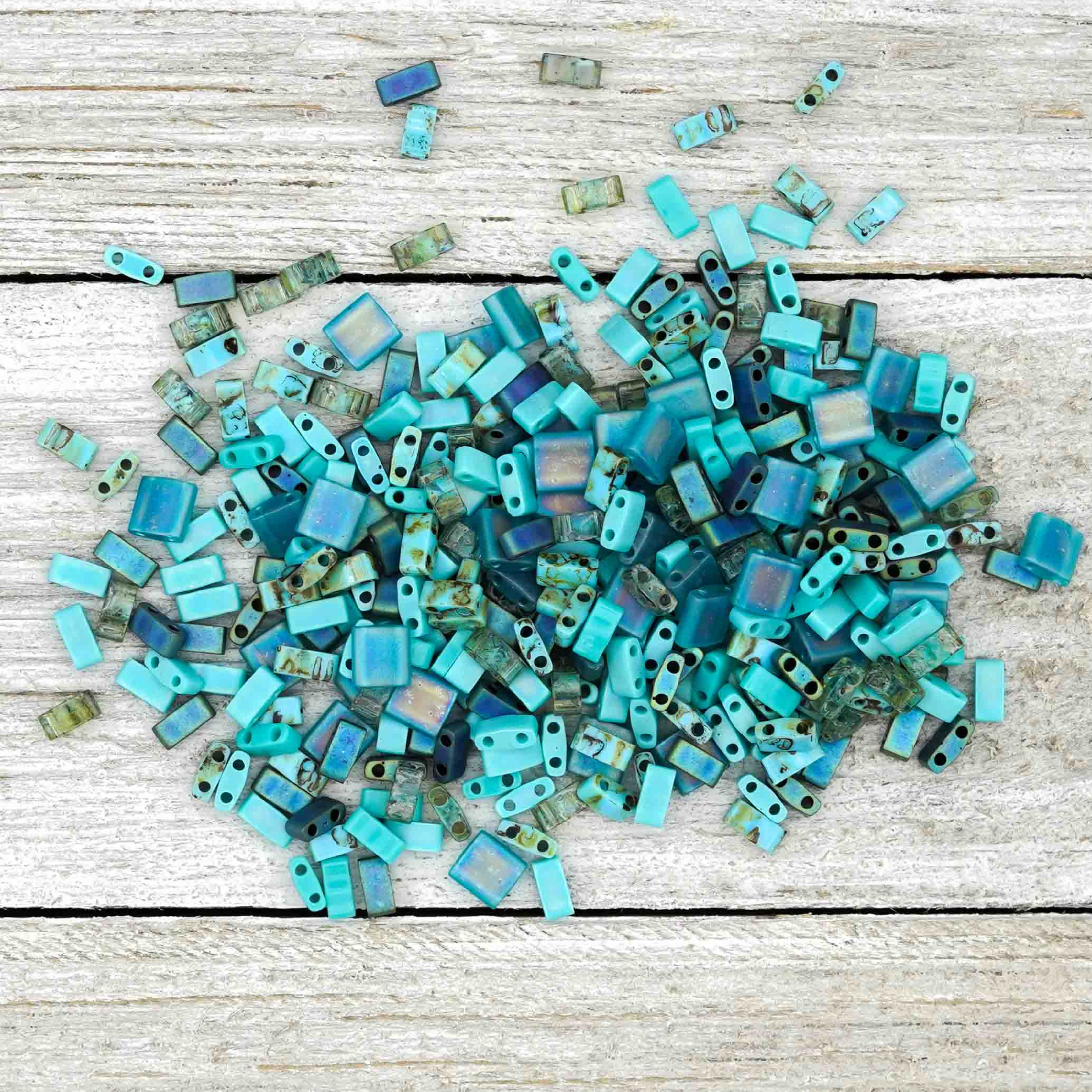 a pile of blue glass cubes on a white surface