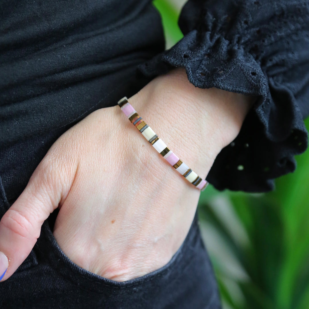 a woman's hand with a bracelet on it