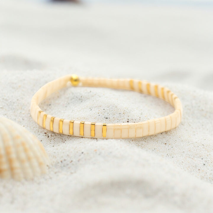 a close up of a bracelet on a beach