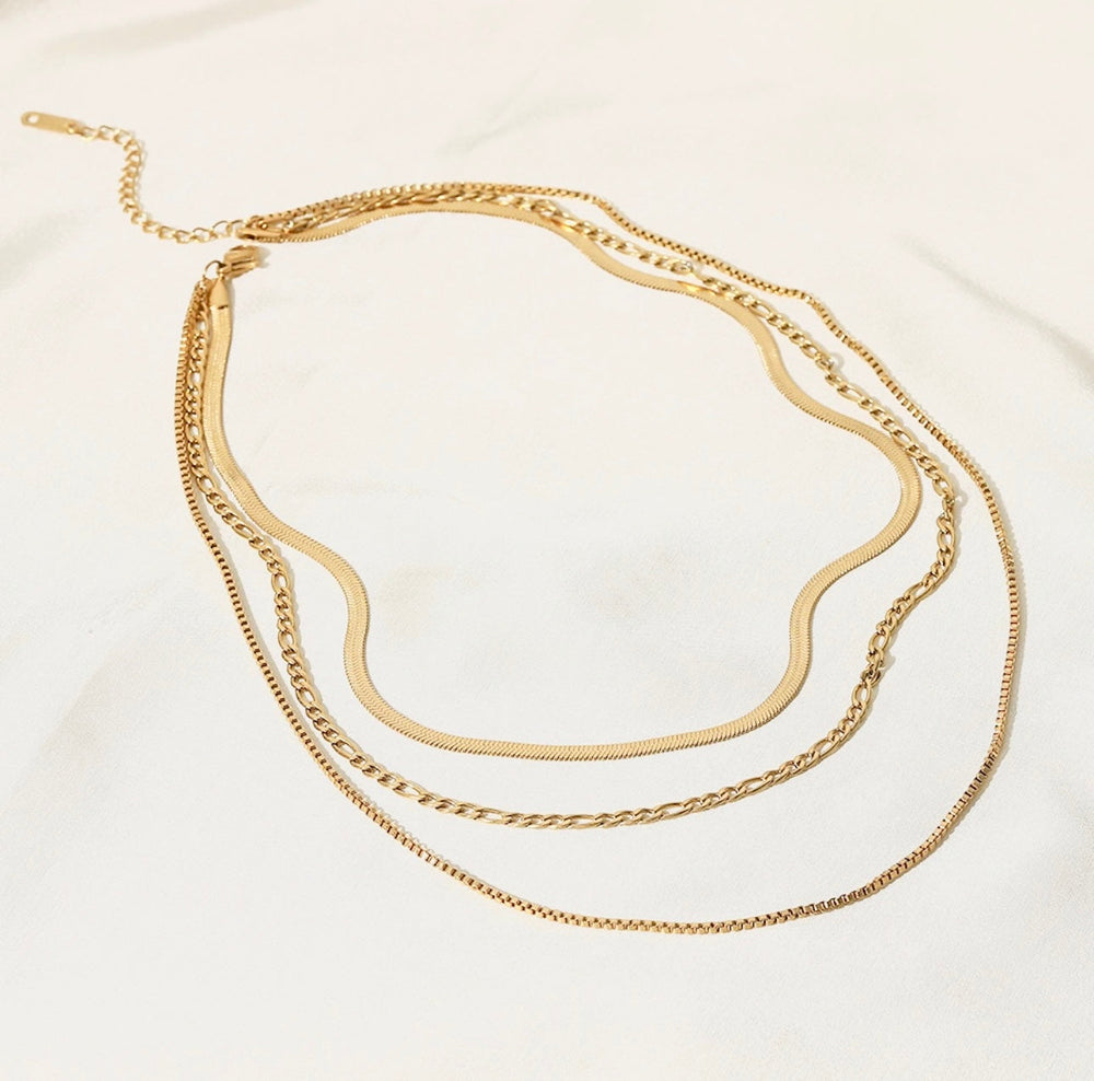 a close up of a necklace on a white surface