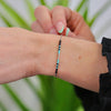 a woman's arm with a bracelet on it