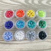 a bunch of different colors of beads in a container