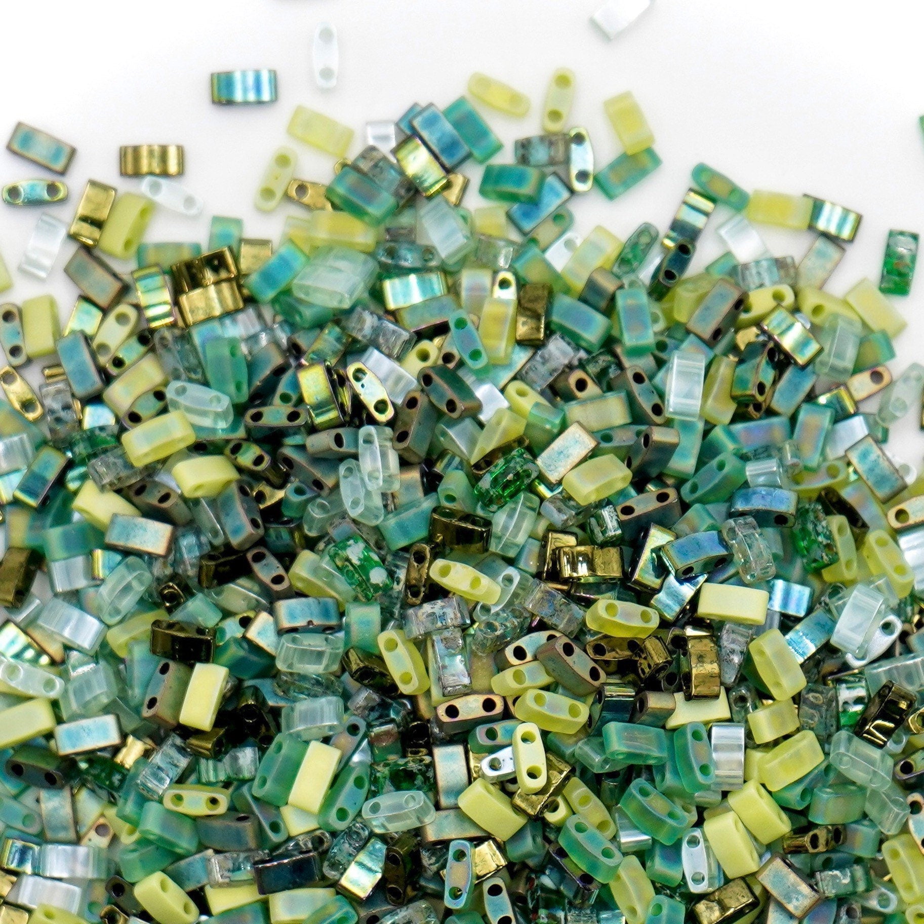 a pile of green and yellow glass beads