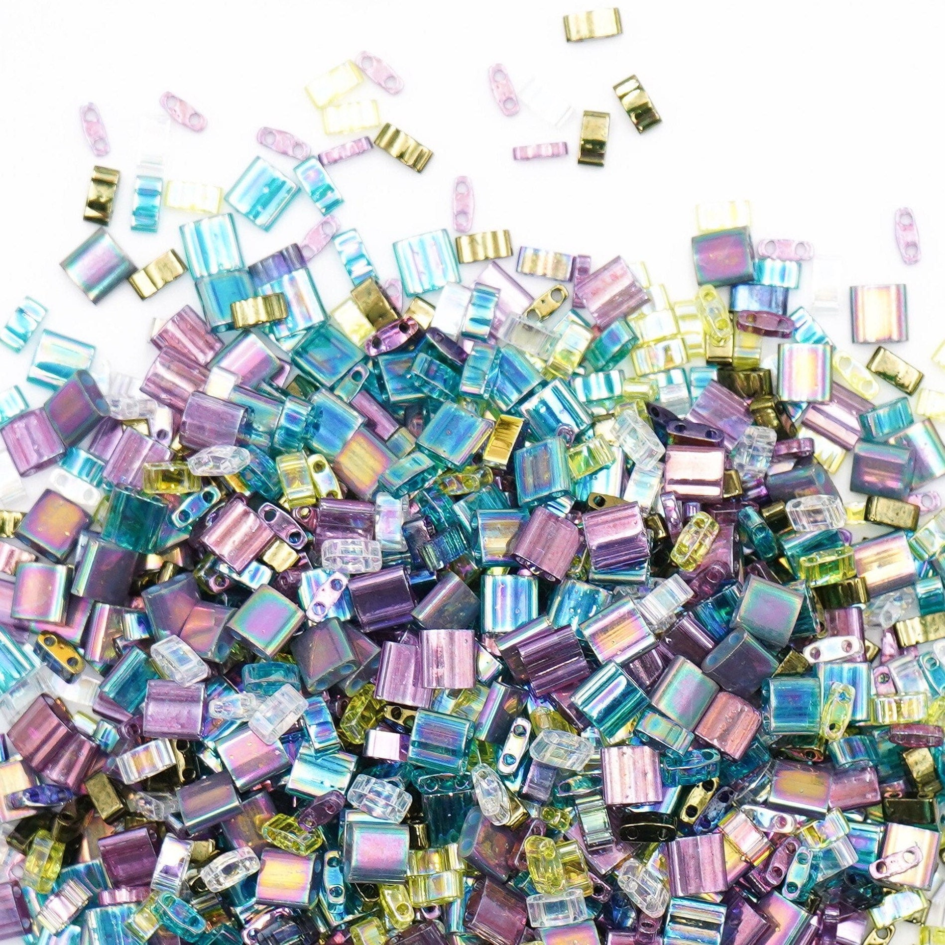 a pile of purple and green glass beads