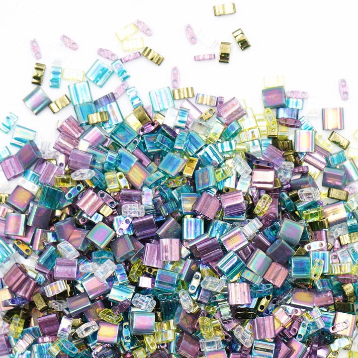 a pile of purple and green glass beads