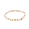 a gold and white beaded bracelet on a white background