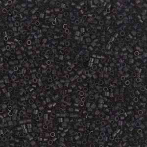 a pile of black beads on a white background