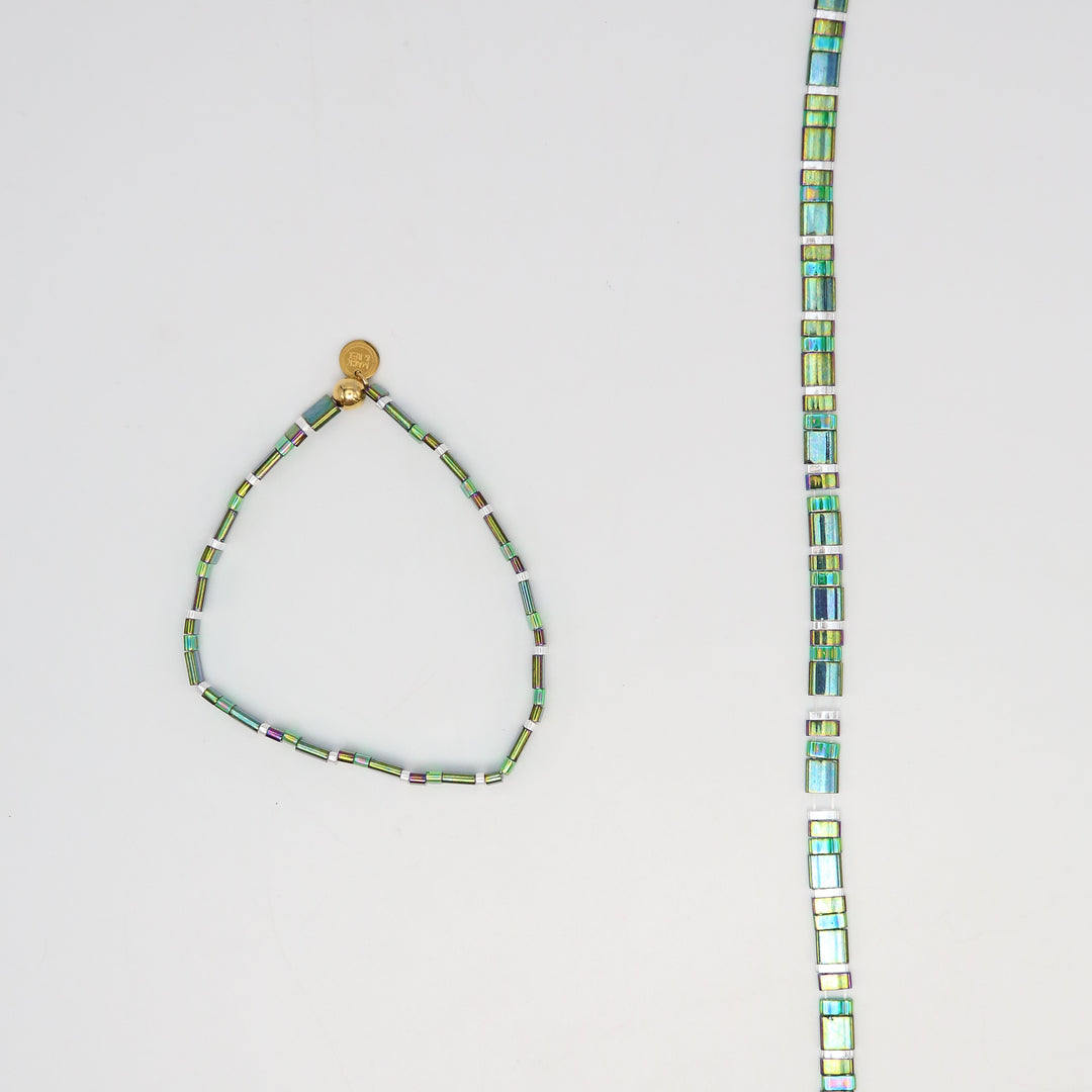 Necklace with multicolored beads on a light gray background