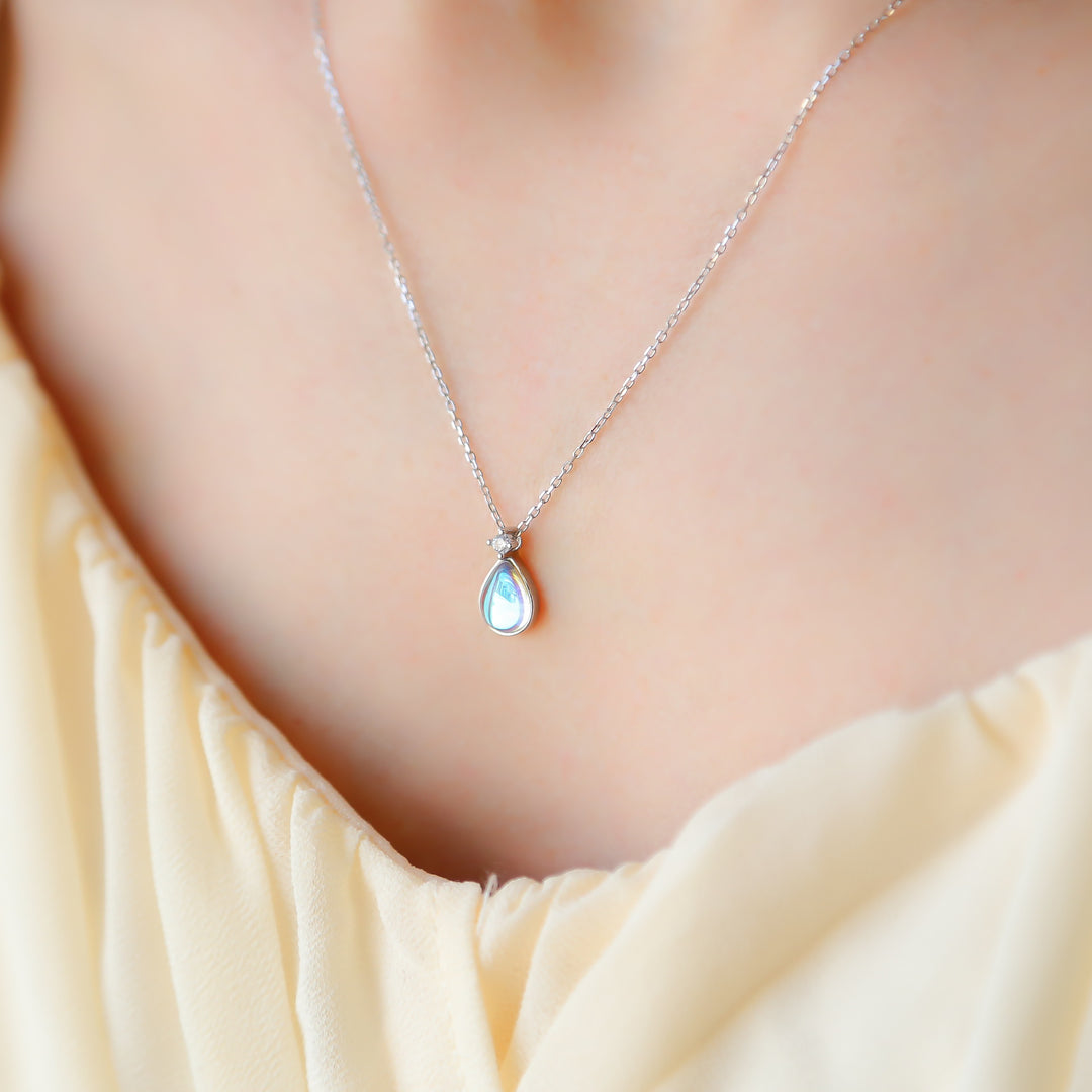 a close up of a woman wearing a necklace