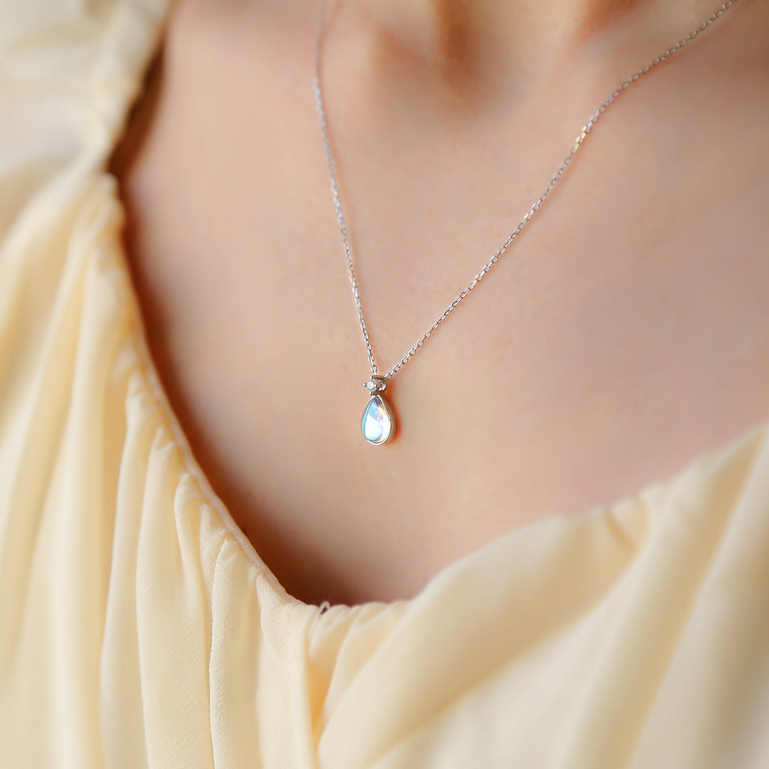 a close up of a woman wearing a necklace