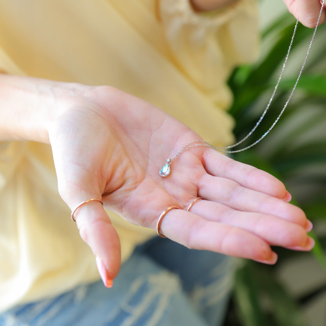 a woman holding out her hand with a ring on it