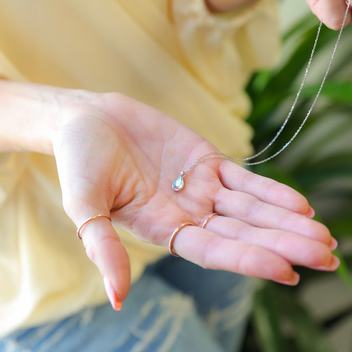 a woman holding out her hand with a ring on it