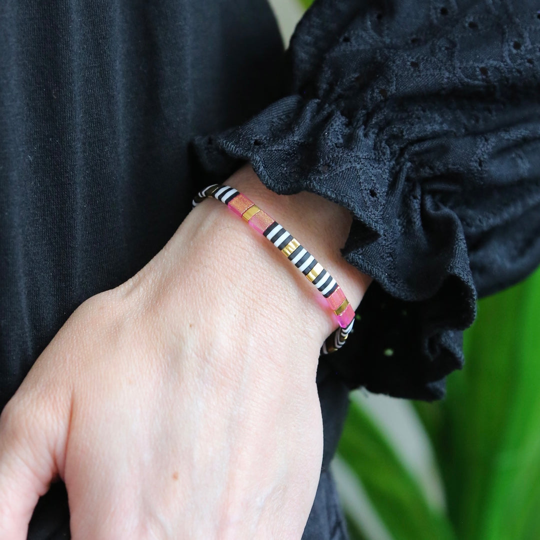 a woman's hand with a bracelet on it