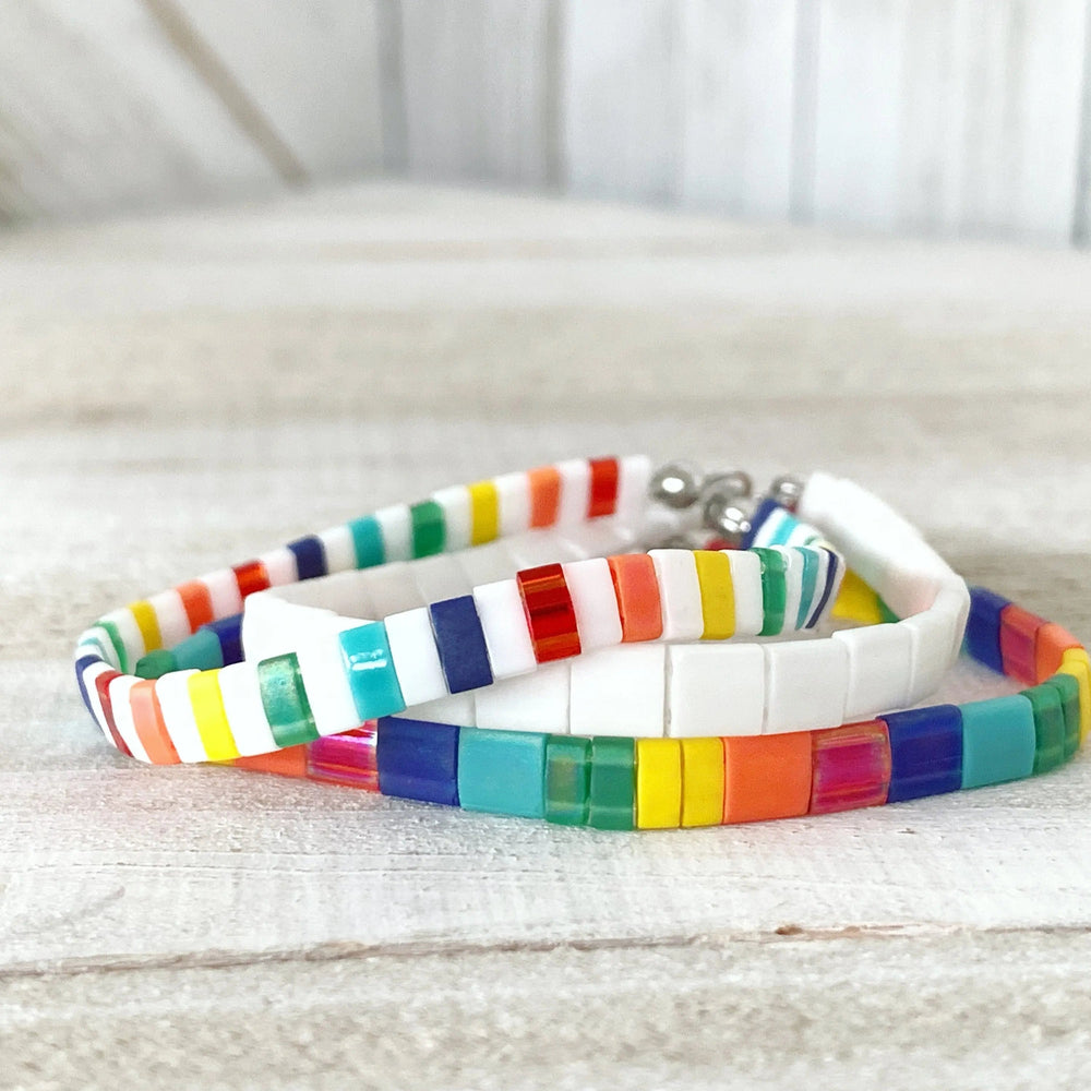 a couple of bracelets sitting on top of a table