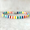 a multicolored bracelet on a white surface