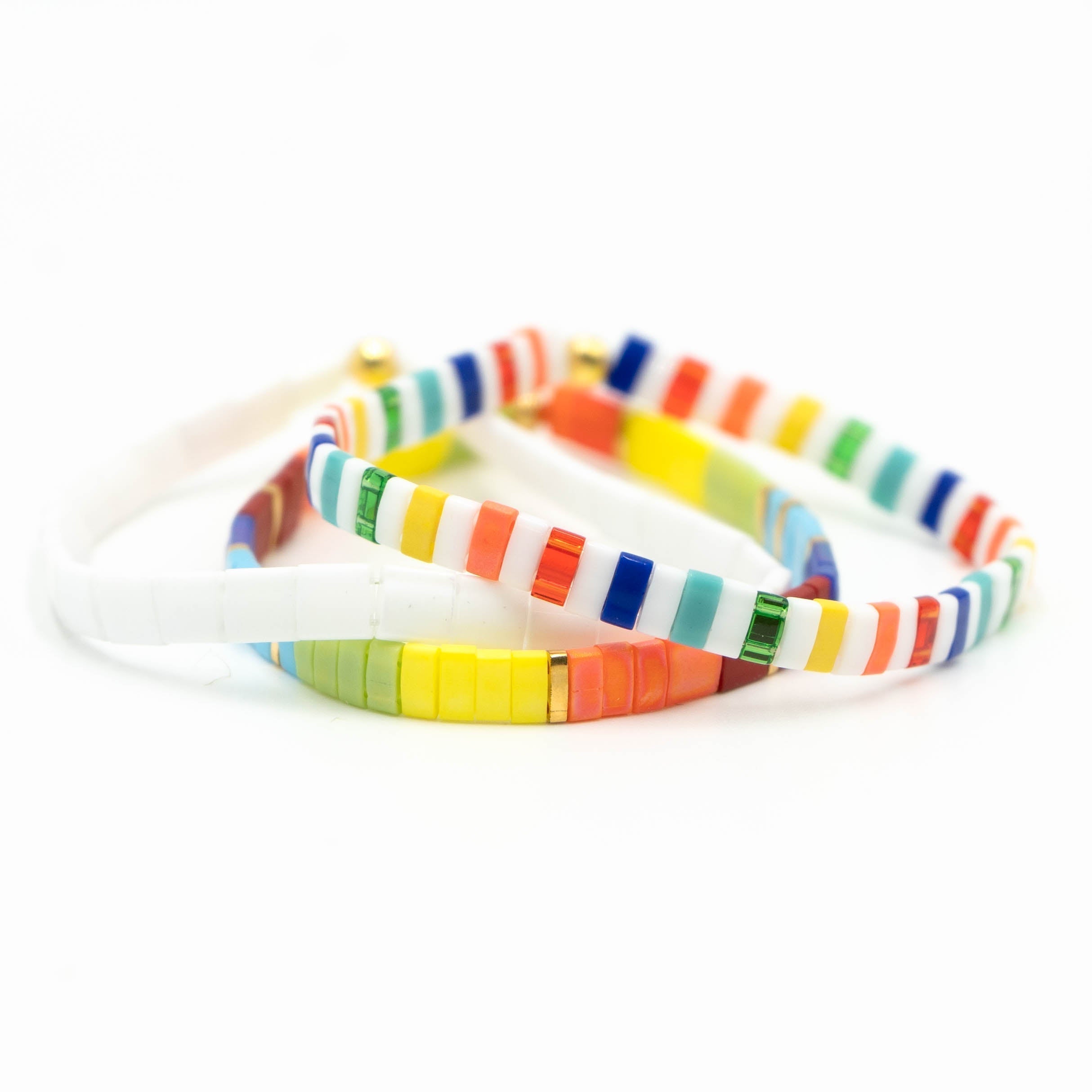 a close up of three bracelets on a white background