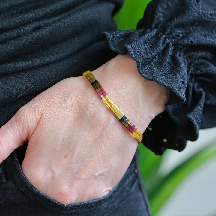 a woman's hand with a bracelet on it