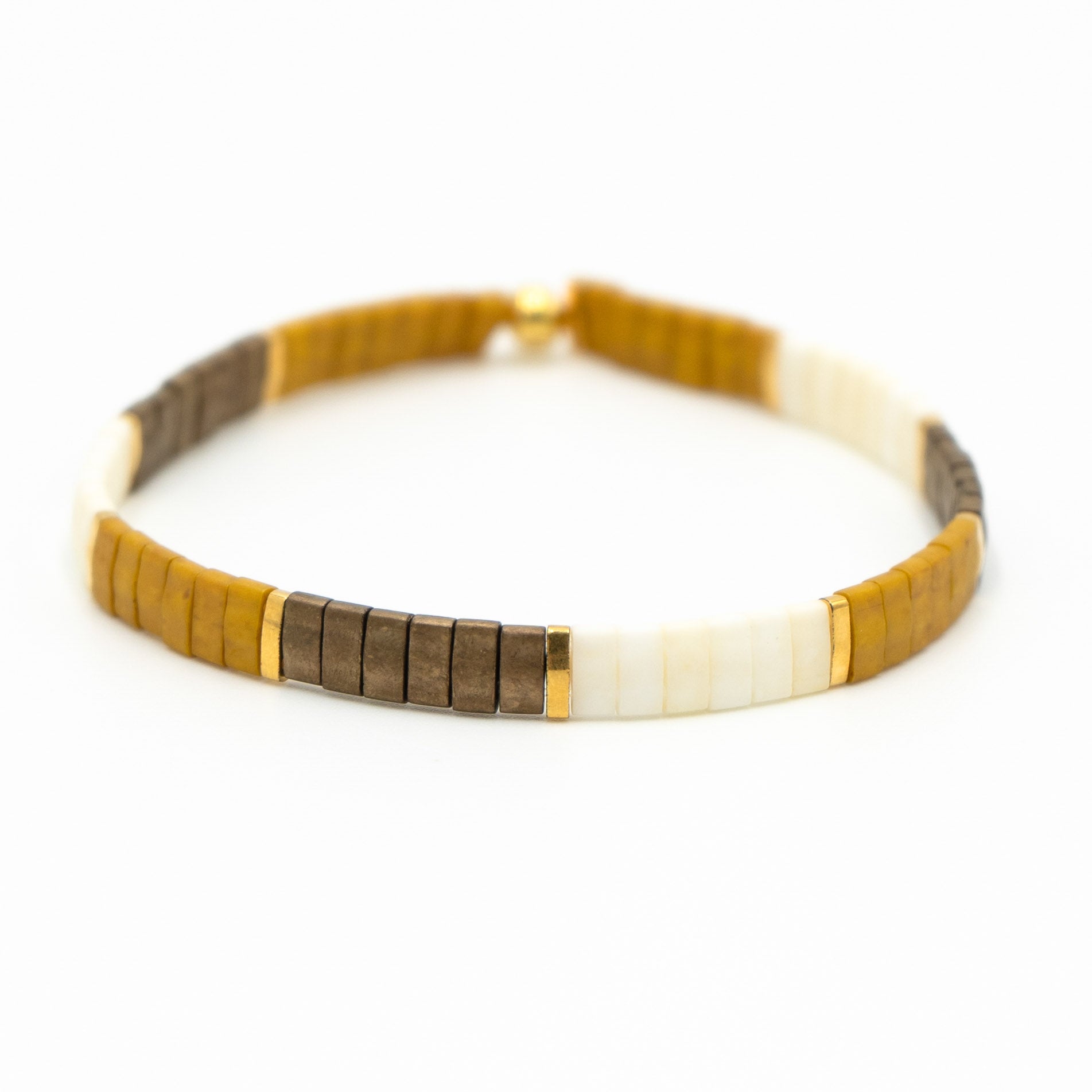 a brown and white bracelet on a white background