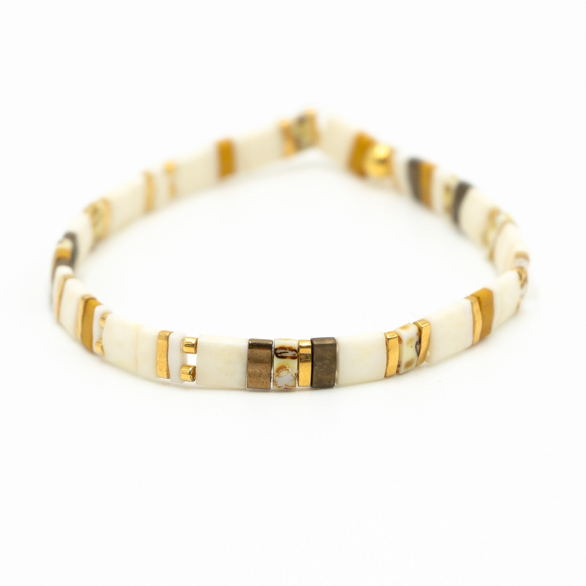 a white bracelet with gold and white beads
