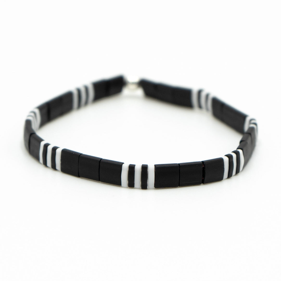 a black and white beaded bracelet on a white background