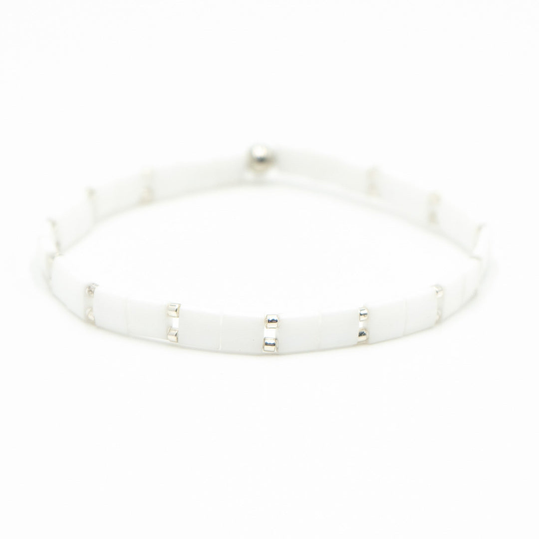 a close up of a white bracelet on a white background