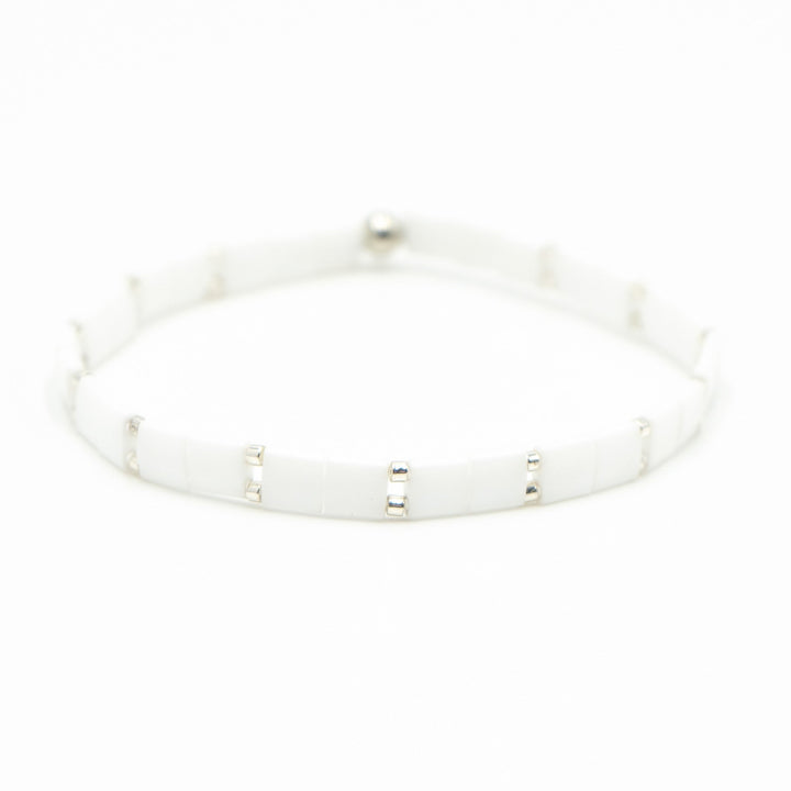 a close up of a white bracelet on a white background