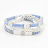 a couple of blue and white bracelets on a white surface